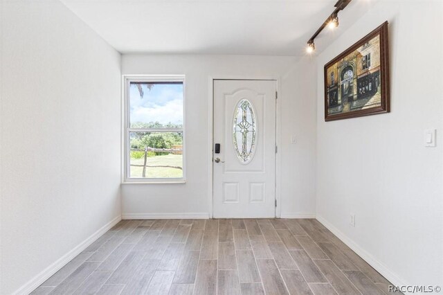 foyer entrance featuring wood-type flooring and track lighting