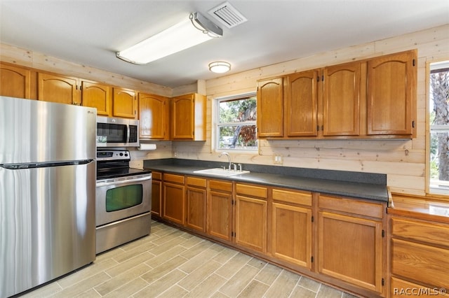 kitchen featuring sink, light hardwood / wood-style floors, and appliances with stainless steel finishes