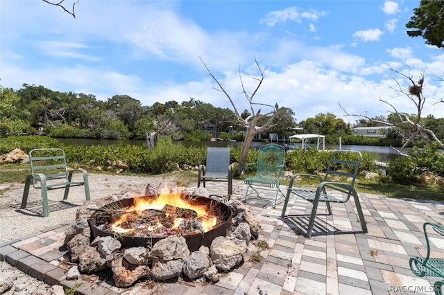 view of patio featuring a fire pit and a water view