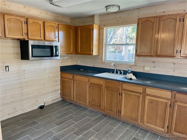 kitchen with sink and wood walls