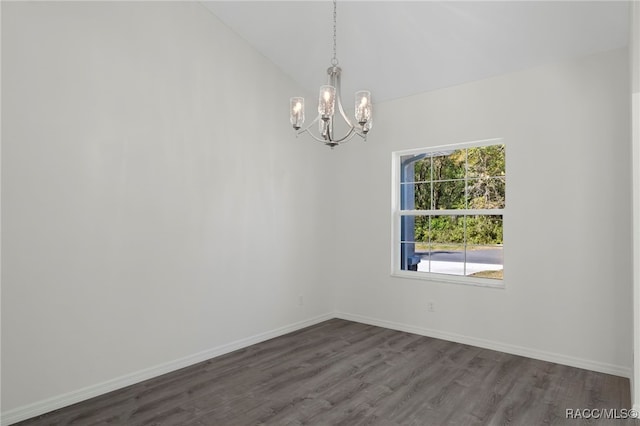 unfurnished room featuring baseboards, a notable chandelier, lofted ceiling, and dark wood-style floors