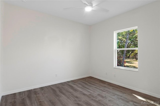 unfurnished room featuring a ceiling fan, wood finished floors, and baseboards