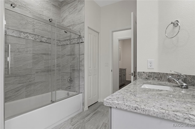 bathroom featuring vanity and enclosed tub / shower combo