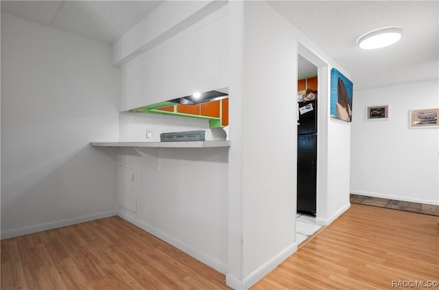 hallway with hardwood / wood-style flooring