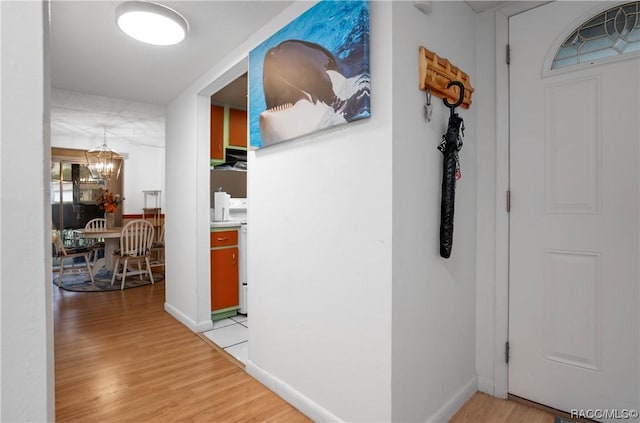 2400 Forest Dr Unit 103, Inverness, FL 34453 - hall featuring a chandelier and light wood-type flooring