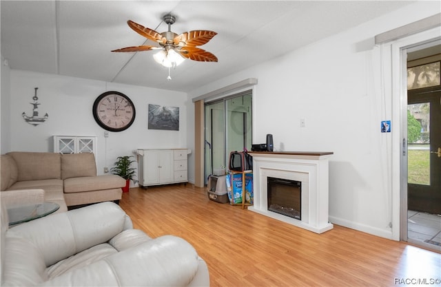 living room featuring ceiling fan and light wood-type flooring