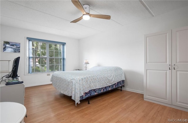 2400 Forest Dr Unit 103, Inverness, FL 34453 - bedroom with light wood-style floors, baseboards, and a ceiling fan
