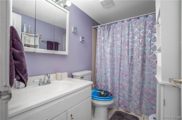 bathroom with a shower with curtain, tile patterned flooring, vanity, and toilet