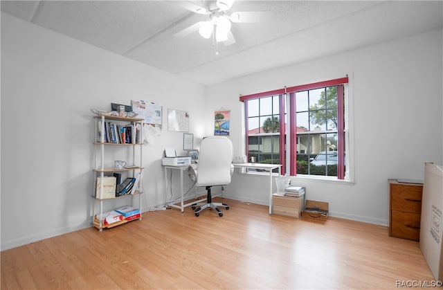 office area with a textured ceiling, light hardwood / wood-style flooring, and ceiling fan