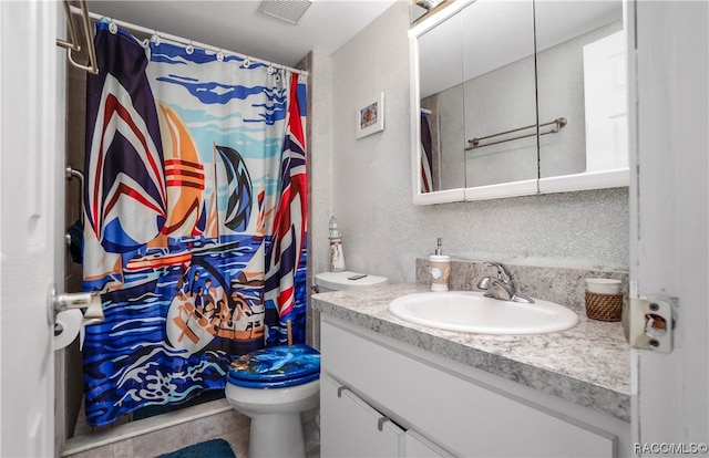 bathroom featuring tile patterned flooring, vanity, and toilet