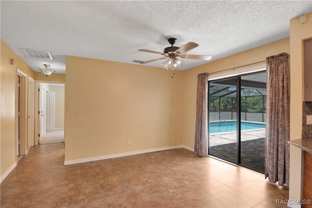 3231 S Eagle Pt, Inverness, FL 34450 - empty room featuring a ceiling fan, a textured ceiling, and light tile patterned floors