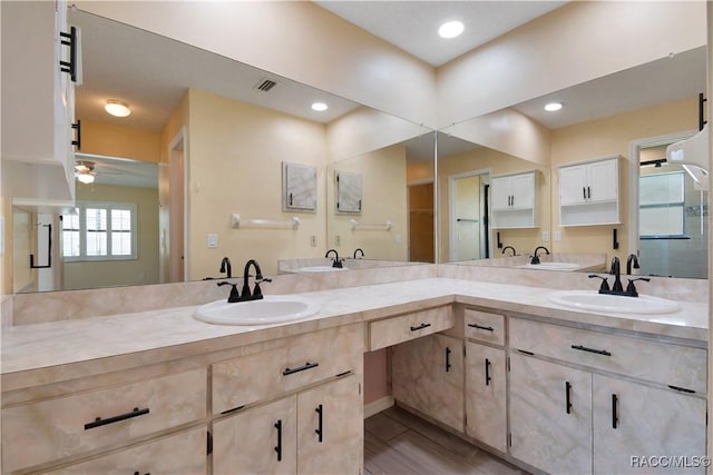 3231 S Eagle Pt, Inverness, FL 34450 - bathroom with double vanity, a ceiling fan, and a shower stall
