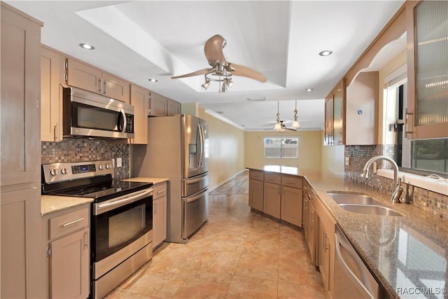 3231 S Eagle Pt, Inverness, FL 34450 - kitchen with appliances with stainless steel finishes, a ceiling fan, tasteful backsplash, recessed lighting, and a tray ceiling