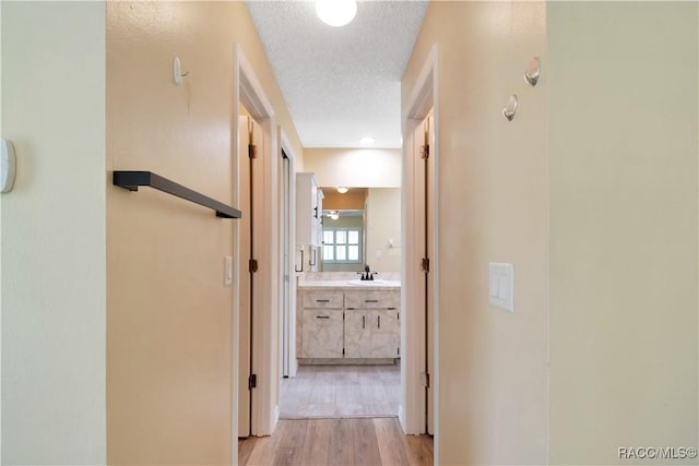 3231 S Eagle Pt, Inverness, FL 34450 - corridor featuring a textured ceiling and light wood-style flooring