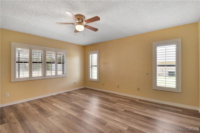 3231 S Eagle Pt, Inverness, FL 34450 - unfurnished room with a ceiling fan, a textured ceiling, and wood finished floors