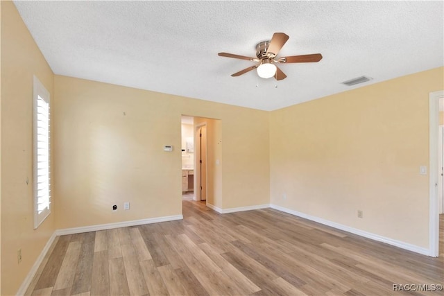 3231 S Eagle Pt, Inverness, FL 34450 - spare room featuring a ceiling fan, light wood-type flooring, and a textured ceiling