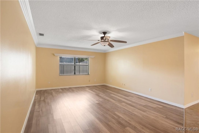 3231 S Eagle Pt, Inverness, FL 34450 - spare room with a textured ceiling, ceiling fan, ornamental molding, and wood finished floors