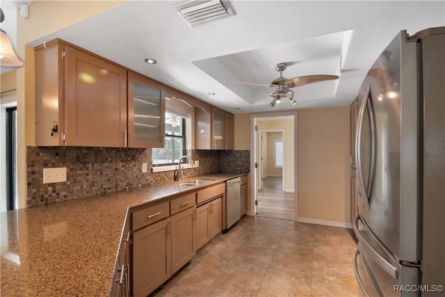 3231 S Eagle Pt, Inverness, FL 34450 - kitchen featuring appliances with stainless steel finishes, backsplash, a ceiling fan, glass insert cabinets, and a raised ceiling