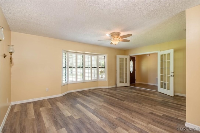 3231 S Eagle Pt, Inverness, FL 34450 - unfurnished room with french doors, a ceiling fan, wood finished floors, and a textured ceiling