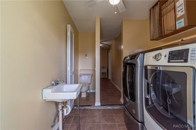 3231 S Eagle Pt, Inverness, FL 34450 - laundry area featuring independent washer and dryer, ceiling fan, dark tile patterned flooring, and a textured ceiling
