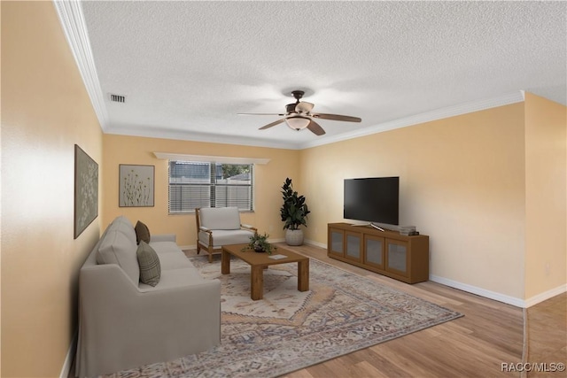 3231 S Eagle Pt, Inverness, FL 34450 - living room with crown molding, a textured ceiling, a ceiling fan, and wood finished floors