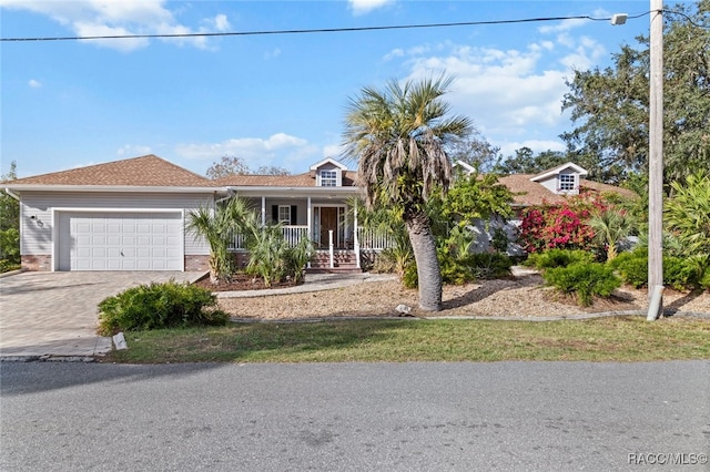 view of front of home with a porch and a garage