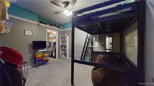 bedroom featuring ceiling fan, a closet, and carpet floors