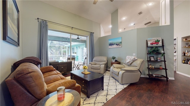 living room with hardwood / wood-style floors and high vaulted ceiling