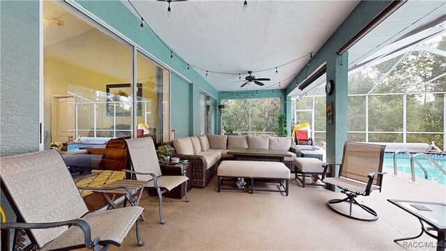 view of patio with ceiling fan, a lanai, and an outdoor hangout area