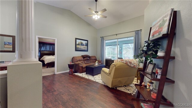 living room featuring ornate columns, ceiling fan, wood-type flooring, and vaulted ceiling