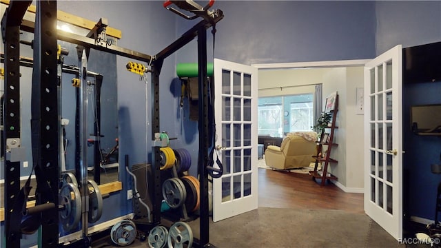 workout area with french doors and dark hardwood / wood-style floors