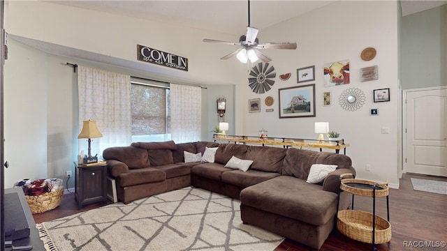 living room with hardwood / wood-style floors, ceiling fan, and high vaulted ceiling