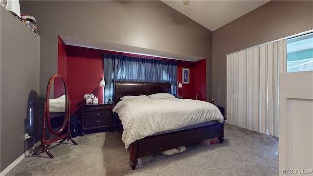 carpeted bedroom with lofted ceiling