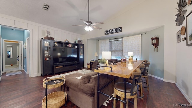 living room with dark hardwood / wood-style floors, ceiling fan, and vaulted ceiling