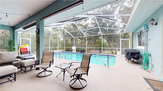 view of pool with area for grilling, a patio, an outdoor living space, and glass enclosure