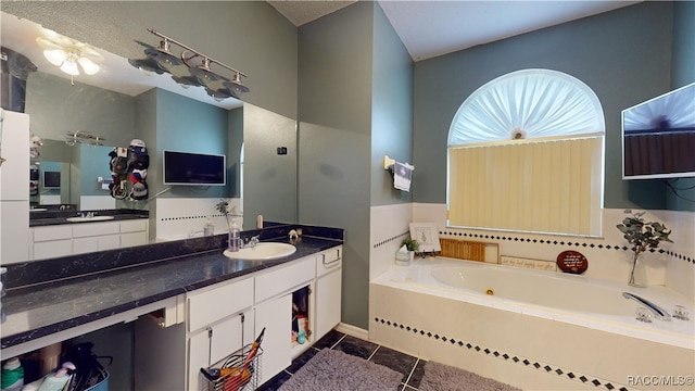 bathroom featuring tile patterned floors, a bathtub, and vanity