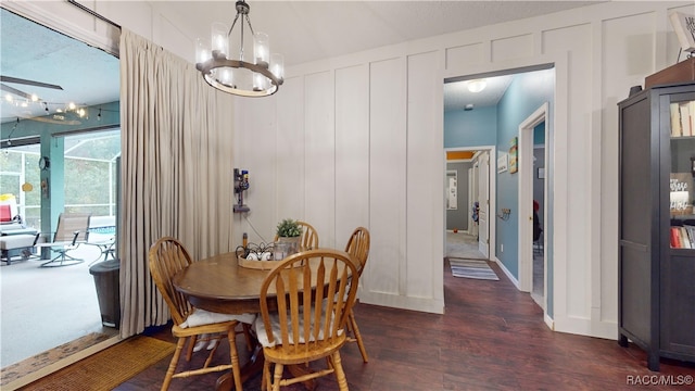 dining area featuring dark hardwood / wood-style flooring and a notable chandelier