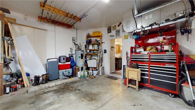 garage with a workshop area and electric water heater