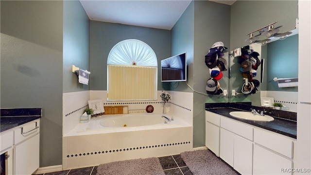 bathroom featuring a bathtub, tile patterned flooring, and vanity