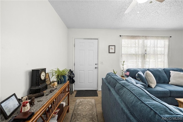 living area featuring ceiling fan and a textured ceiling