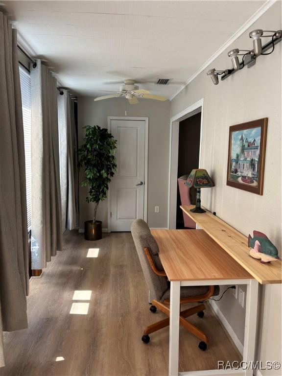 office area featuring dark wood-type flooring and ceiling fan