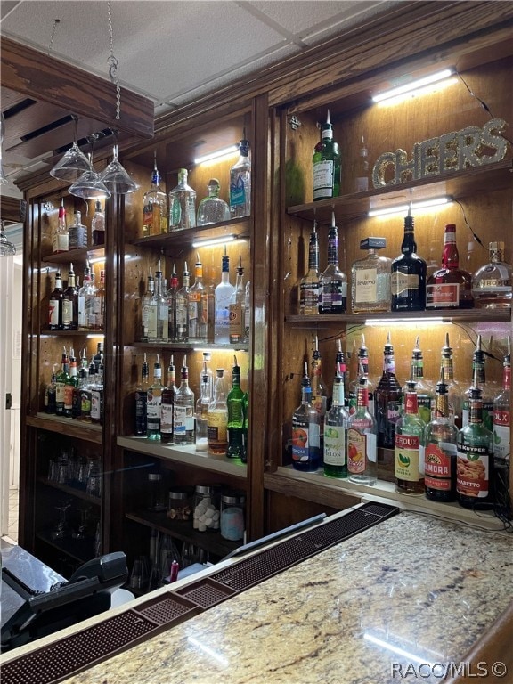 bar featuring light stone countertops