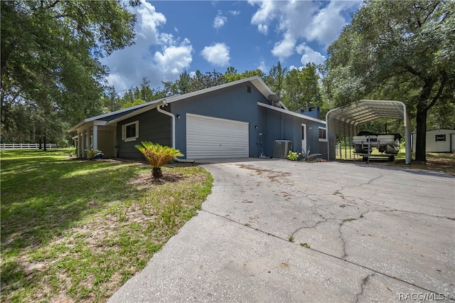 view of property exterior with central AC, a yard, a carport, and a garage