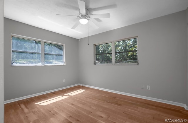 empty room with ceiling fan and light wood-type flooring