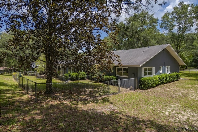 view of side of home featuring a lawn