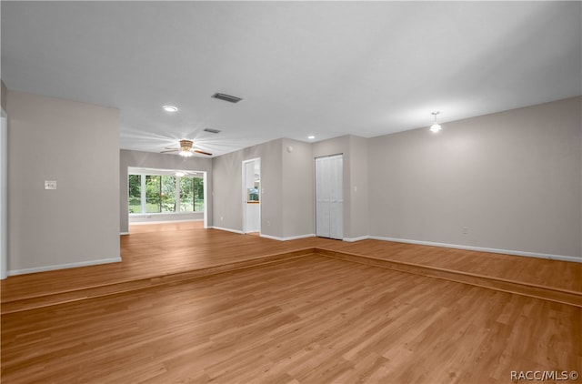 empty room featuring ceiling fan and light hardwood / wood-style flooring