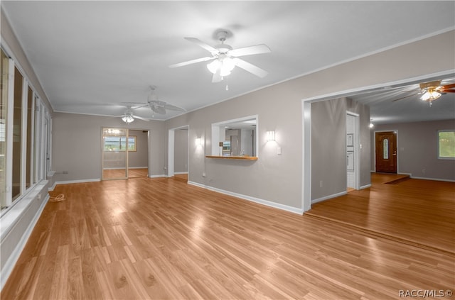 unfurnished living room featuring light hardwood / wood-style flooring and crown molding