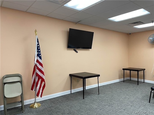 miscellaneous room featuring a drop ceiling and dark carpet