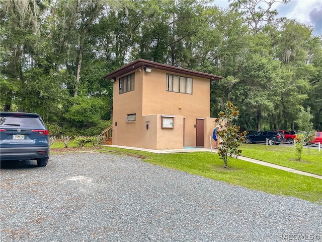 view of side of property with a yard