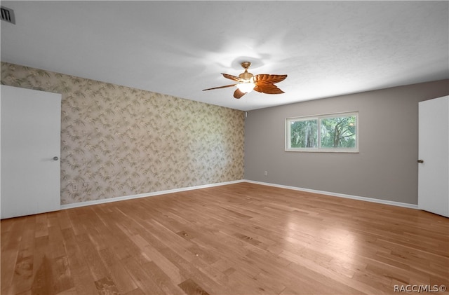 empty room featuring ceiling fan and light hardwood / wood-style floors